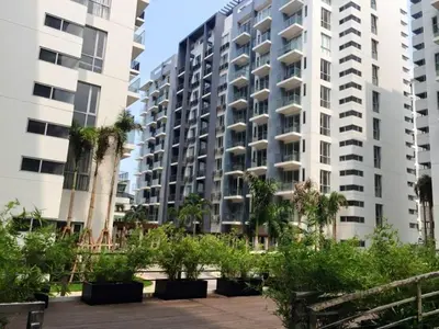 a large apartment building with palm trees in front of it at One Palm Tree Condo in Manila