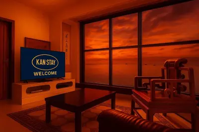 a living room with a television with a view of a sunset at \u5eb7\u5bbf \u6ec4\u6d77\u5c45 Sea Horizon in Sampong