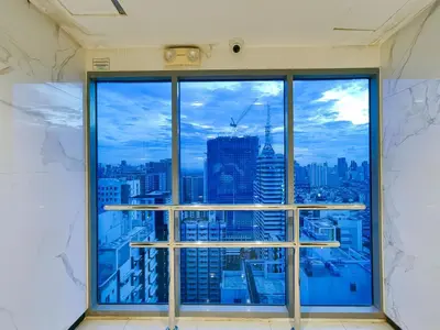an office window with a view of the city at 1BR Condotel with Balcony at FAME Residences #FM03-1 in Manila