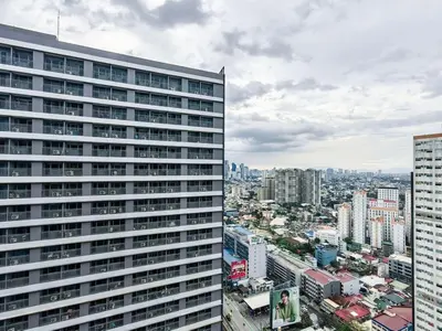 a view of a tall building in a city at 1BR Condotel with Balcony at FAME Residences #FM04-1 in Manila