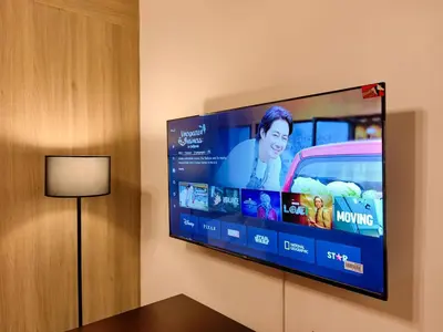 a flat screen tv hanging on a wall at 1BR Condotel with Balcony at FAME Residences #FM04-1 in Manila