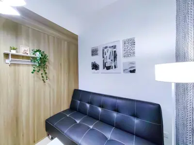 a black leather couch in a waiting room at 1BR Condotel with Balcony at FAME Residences #FM07-1 in Manila