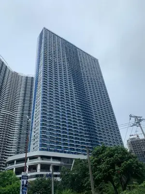 a tall building with trees in front of it at Makati City Ayala Ave Extension Condo with Fast Internet in Manila