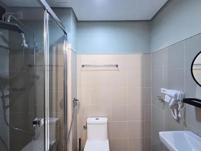 a bathroom with a shower and a toilet and a sink at 1BR Condotel with Balcony at FAME Residences #FM10-1 in Manila