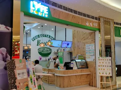 a fast food restaurant with people sitting at a counter at 1BR Condotel with Balcony at FAME Residences #FM12-1 in Manila