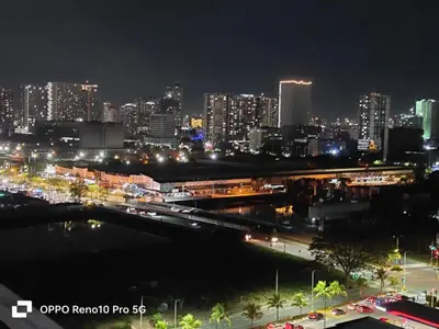 a city skyline at night with a train station at JAO Cozy Stay - Mall of Asia in Sampong