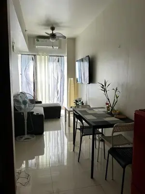a living room with a table and a couch at Bakshi Lovely Haven 3 in Manila
