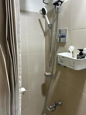 a shower in a bathroom with a sink at Bakshi Lovely Haven 3 in Manila