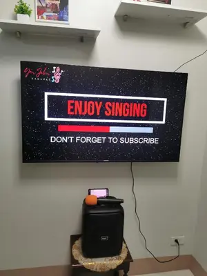 a sign on a wall that says enjoy singing dont forget to subscribe at Mall of Asia condotel shore 3 residence 3 in Manila
