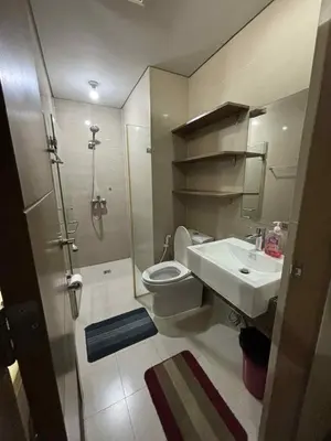 a bathroom with a toilet and a sink at Rqui Rooms Near airport and Newport World Resorts in Manila