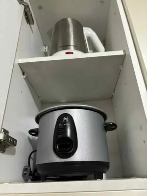 a toaster sitting on a shelf in a kitchen at Rqui Rooms Near airport and Newport World Resorts in Manila