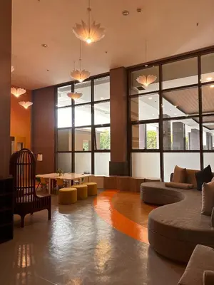 a living room with couches and a table and windows at Close dont book in Manila