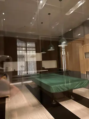 a green ping pong table in a room at Close dont book in Manila