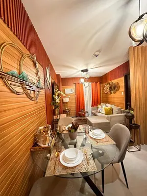 a dining room with a table and chairs and a couch at Close dont book in Manila
