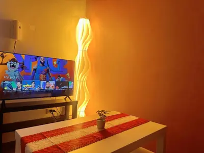 a living room with a television with a light at SMDC AIR Residences in Manila