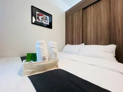 a bedroom with a white bed with white socks on it at 1BR Condotel with Balcony at FAME Residences #FM20-1 in Manila