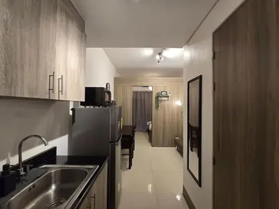 a kitchen with a sink and a refrigerator at 1BR Condotel with Balcony at FAME Residences #FM21-1 in Manila