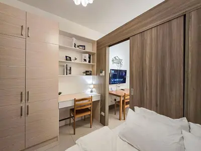 a bedroom with a desk and a bed and a desk at 1BR Condotel with Balcony at FAME Residences #FM22-1 in Manila