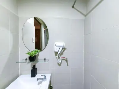 a white bathroom with a sink and a mirror at 1BR Condotel with Balcony at FAME Residences #FM28-1 in Manila
