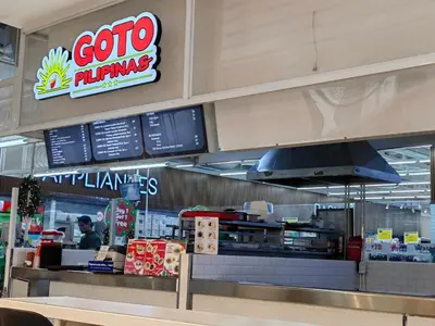 a fast food restaurant with a counter with a person at 1BR Condotel with Balcony at FAME Residences #FM30-1 in Manila