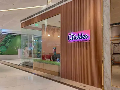 a store with a sign on the side of a building at 1BR Condotel with Balcony at FAME Residences #FM31-1 in Manila