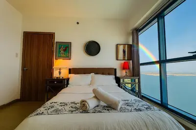 a bedroom with a large bed with a rainbow at \u5eb7\u5bbf \u89c0\u703e\u9f4b Guan Lanzhai Studio in Sampong