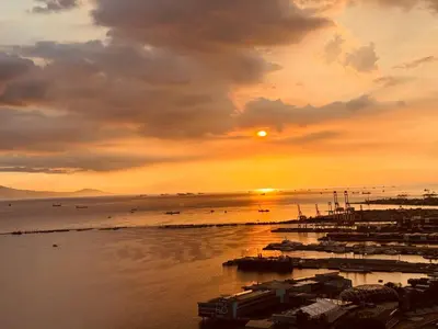 a sunset over a harbor with boats in the water at \u5eb7\u5bbf \u89c0\u703e\u9f4b Guan Lanzhai Studio in Sampong