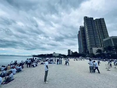a group of people on a beach with buildings at \u5eb7\u5bbf \u6674\u7a97\u5c45 Bright Window Room in Sampong