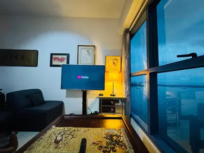 a living room with a large window and a tv at \u5eb7\u5bbf \u6674\u7a97\u5c45 Bright Window Room in Sampong