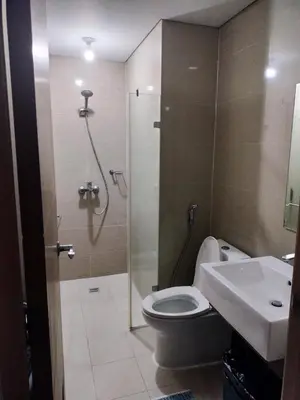 a bathroom with a shower and a toilet and a sink at Rooms Across NAIA Terminal 3 Pasay in Manila