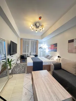 a living room with a bed and a couch at The Fresh Escape 2 in Manila