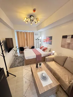 a living room with a bed and a couch at The Fresh Escape 2 in Manila