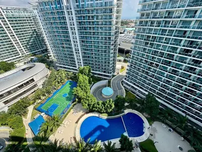 an aerial view of a large building with a pool at SM Bicutan by Bahamas in Manila