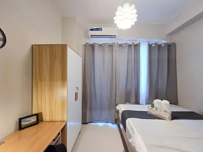 a hospital room with two beds and a window at 1BR Condotel with Balcony at FAME Residences #FM32-1 in Manila
