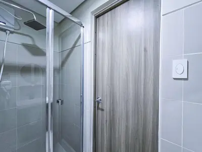 a shower with a glass door in a bathroom at 1BR Condotel with Balcony at FAME Residences #FM34-1 in Manila