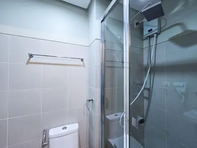 a bathroom with a glass shower and a toilet at 1BR Condotel with Balcony at FAME Residences #FM34-1 in Manila