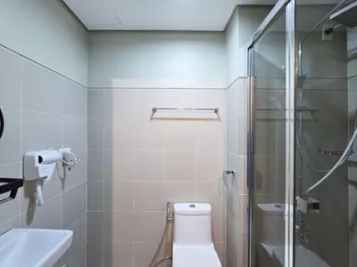 a bathroom with a shower and a toilet and a sink at 1BR Condotel with Balcony at FAME Residences #FM34-1 in Manila