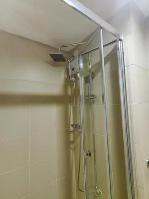 a shower with a glass door in a bathroom at 1BR Condotel with Balcony at FAME Residences #FM36-1 in Manila