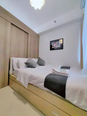 a bedroom with a large bed with white sheets at 1BR Condotel with Balcony at FAME Residences #FM36-1 in Manila