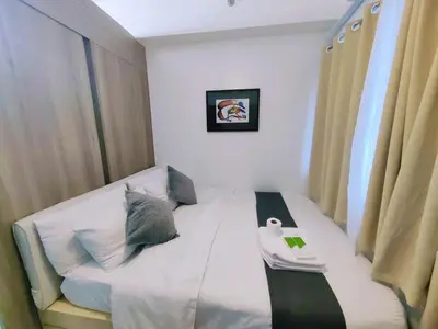 a small room with a bed in a room at 1BR Condotel with Balcony at FAME Residences #FM36-1 in Manila