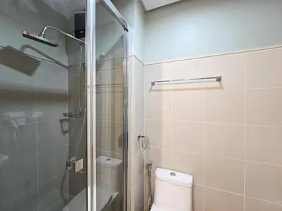 a bathroom with a toilet and a glass shower at 1BR Condotel with Balcony at FAME Residences #FM35-1 in Manila