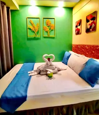 a bedroom with a bed with a stuffed animal on it at Comfystay at Sea Residences in Manila