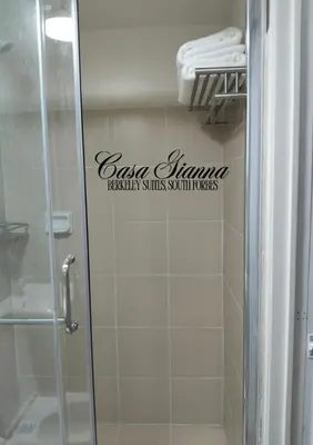 a bathroom with a shower and a sign on the wall at Casa Gianna at Berkeley Suites, South Forbes in Silang
