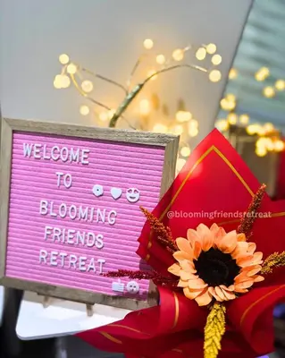a welcome to flowering trends retreat sign next to a flower at Blooming Friends Retreat in Manila