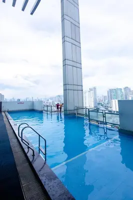 a swimming pool on the top of a building at Makati 1BR High Floor in Manila