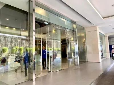 a man standing inside of a glass building at Spacious 2br condo at Quezon City Mezza Residences 1 in Manila