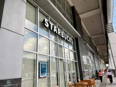 a store with a sign on the side of a building at Spacious 2br condo at Quezon City Mezza Residences 1 in Manila