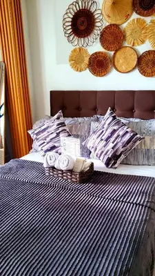 a bed with towels and plates on top of it at Azurejulz Dream Staycation in Manila