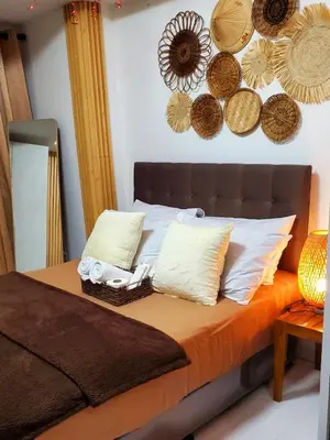 a bedroom with a bed with baskets on the wall at Azurejulz Dream Staycation in Manila