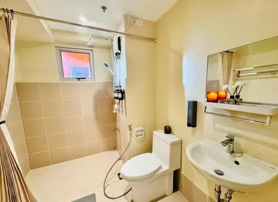 a bathroom with a toilet and a sink at Cozy Vibes Retreat in Makati in Manila